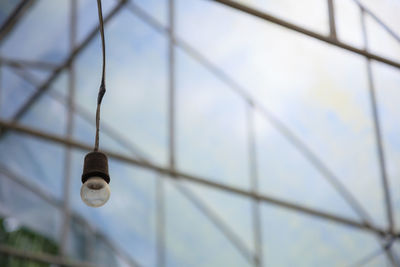 Low angle view of light bulb against sky