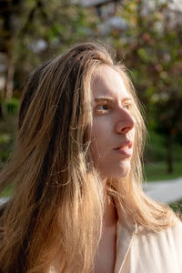 Close-up of young woman in the park, são paulo, brazil. sunlight  in her hair and face. 