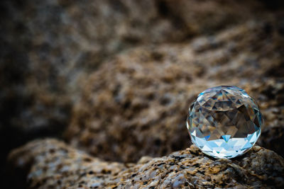 Close-up of crystal ball on rock