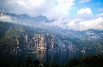 Scenic view of lake and mountains against sky