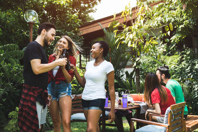 Happy friends in garden during party