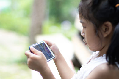 Portrait of woman using mobile phone outdoors