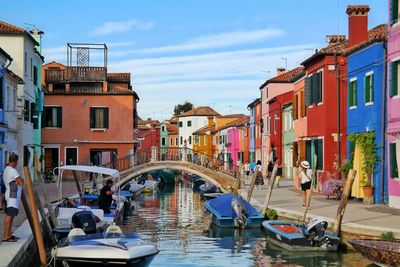Boats in canal with buildings in background