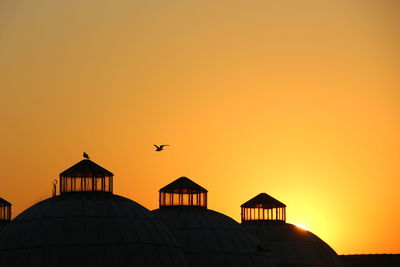 High section of building against sky at sunset