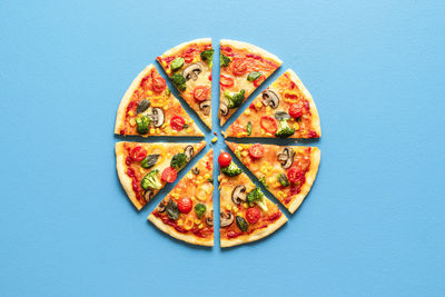 Directly above shot of pizza against blue background