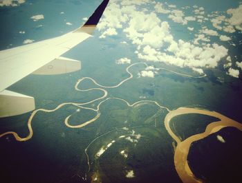 Cropped image of airplane over sea