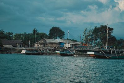 Sailboats in sea against sky