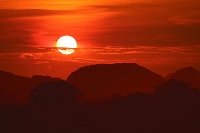 Scenic view of silhouette mountain against orange sky