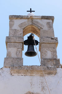 Low angle view of bell tower against sky