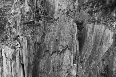 One person climbing dangerous mountain