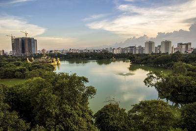 Scenic view of trees and buildings against sky