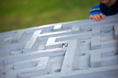 Midsection of child playing puzzle at park