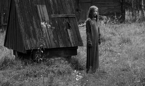 Girl standing on grassy field