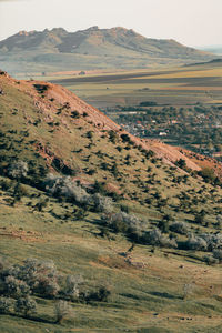 Distant village and mountain range in arid region