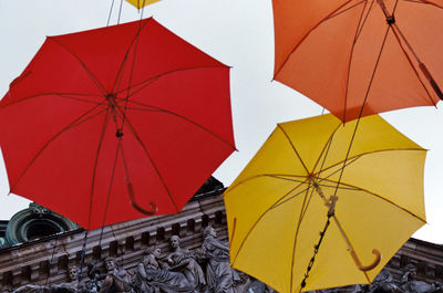 Low angle view of wet umbrella against sky