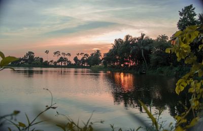 Scenic view of lake against sky at sunset