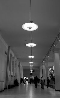 People walking in illuminated building