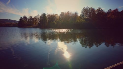 Scenic view of lake against sky at sunset