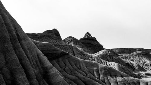 Low angle view of rock formations in desert against clear sky