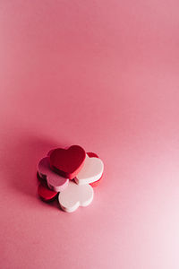 Close-up of heart shape over pink background