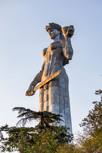 Low angle view of angel statue against clear sky