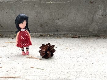 Rear view of girl standing against wall