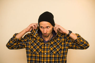 Portrait of young man against wall