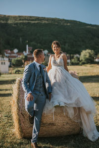 Rear view of couple holding hands