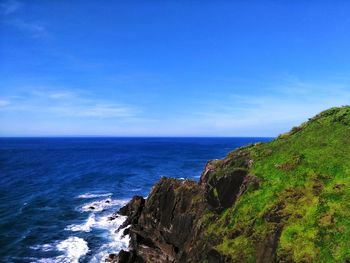 Scenic view of sea against blue sky