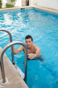 High angle view of man swimming in pool