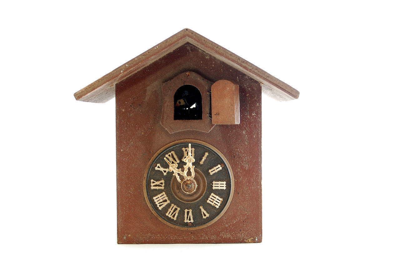 CLOSE-UP OF CLOCK ON WHITE BACKGROUND