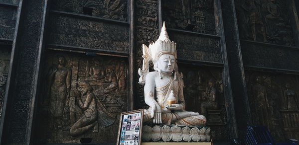 Low angle view of statue against temple