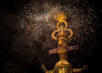 Low angle view of illuminated statue at night