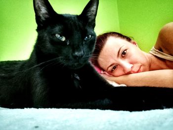 Portrait of cat lying on floor at home