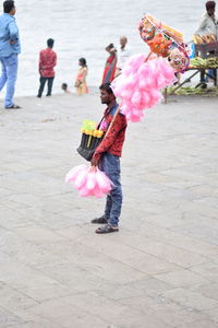 Rear view of women dancing on pink umbrella