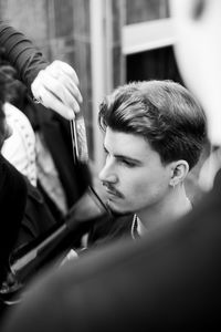 High angle view of man sitting in hair salon