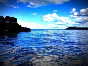 Scenic view of sea against cloudy sky