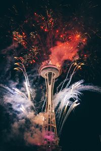 Low angle view of firework display at night