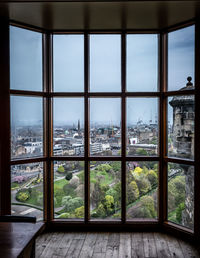 Trees and buildings seen through glass window