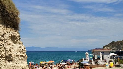 People on beach against sky