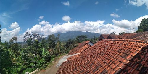 Panoramic view of landscape and houses against sky