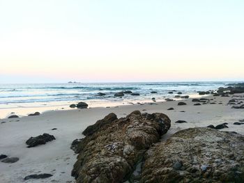 Scenic view of sea against clear sky during sunset