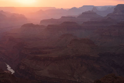 Hazy sunset light spills through the grand canyon in grand canyon national park, arizona