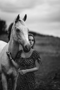 Portrait of young woman with horse