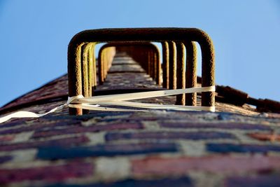 Low angle view of metallic structure against clear sky