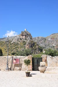 Built structure on mountain against blue sky