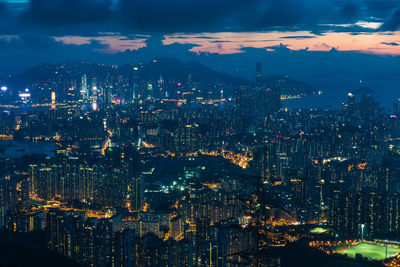 High angle view of illuminated city against sky at night in hong kong 