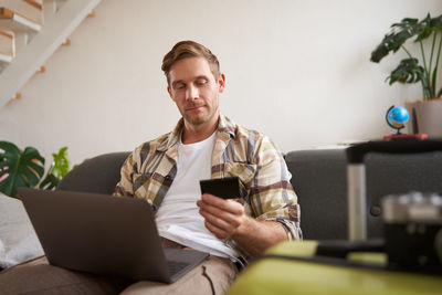 Young man using laptop at home