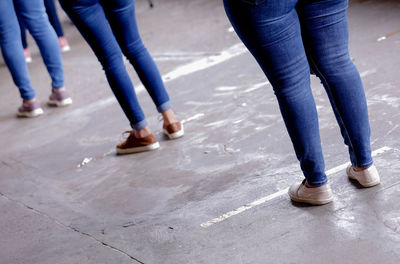 Low section of women standing on street