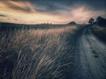 Scenic view of land against sky during sunset